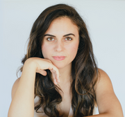 Portrait of a woman with long hair and hand on chin, representing thoughtful contemplation, aligning with WeNatal's nurturing and wellness-focused ethos.